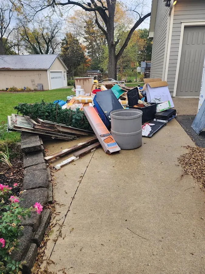 Dumpster being loaded with debris for Residential Dumpster Rental in Apex